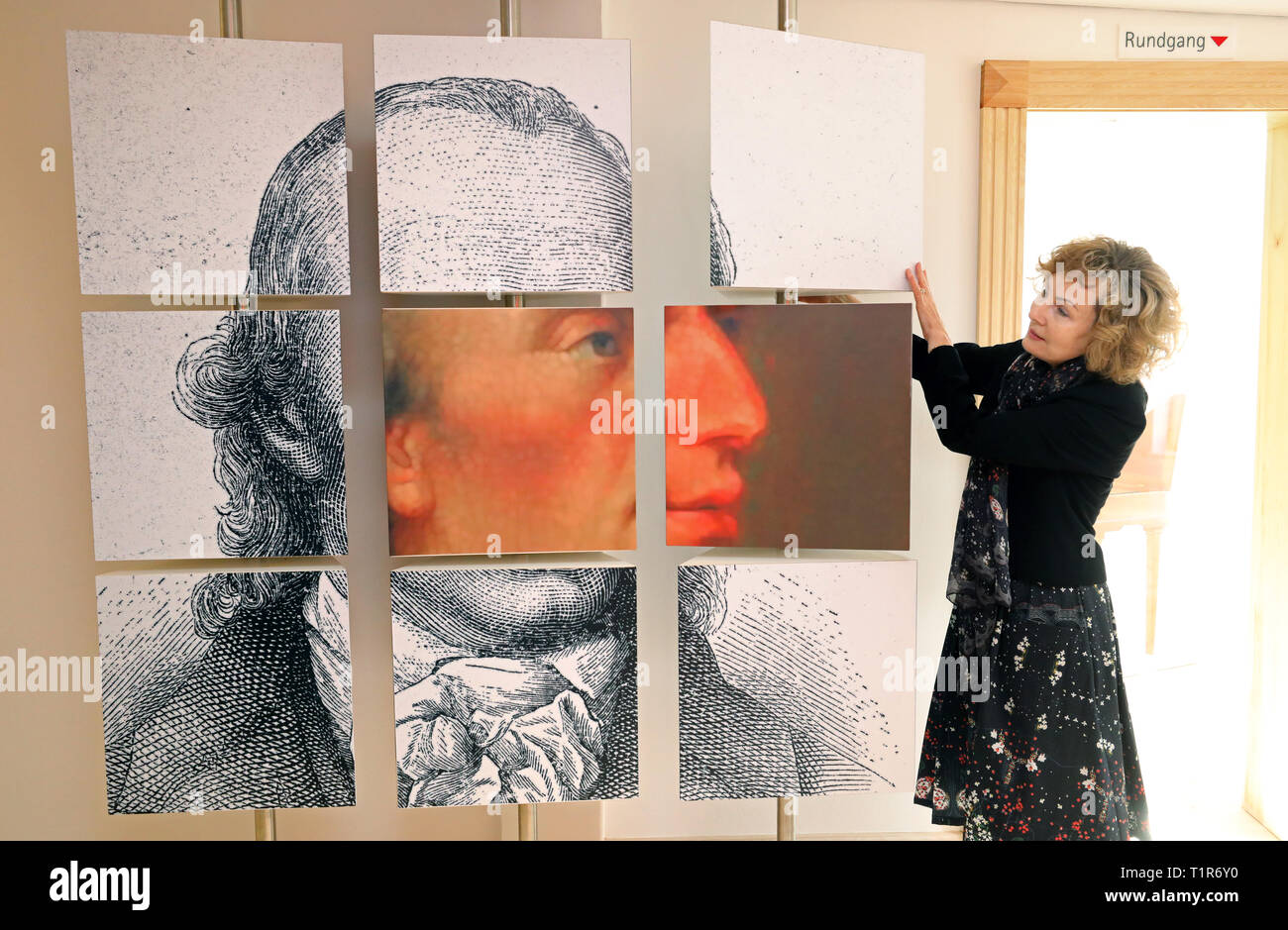 25 March 2019, Mecklenburg-Western Pomerania, Penzlin: In the exhibition 'Johann Heinrich Voß. A Greek from Mecklenburg' in the future Literaturhaus shows Andrea Rudolph, director, a pictorial play of nine parts showing the poet in different views. The rebuilt and extended town school, in which Johann Heinrich Voss (1751-1826) learned from 1759-1766, is opened on 29.03.2019 as a literary house for the Homer translator. The most famous son of the city became known as a poet especially with translations of the 'Odyssey' and the 'Iliad', to which also the legend about the conquest of the ancient Stock Photo