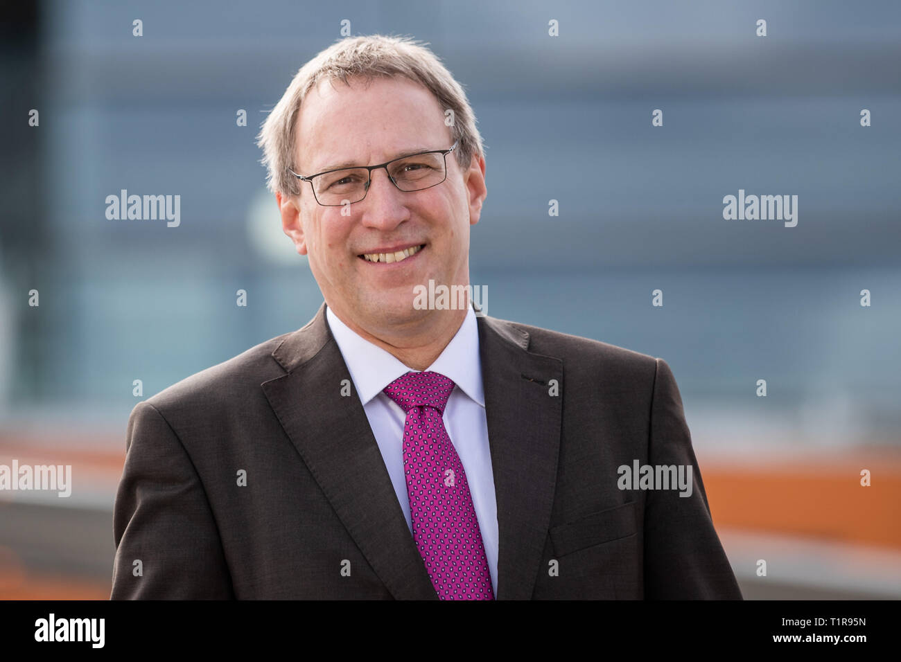 28 March 2019, Bavaria, Nürnberg: Michael Hupe, Managing Director of Albrecht Dürer Airport Nuremberg, stands on the edge of the annual parking lot on the apron. Photo: Daniel Karmann/dpa Stock Photo