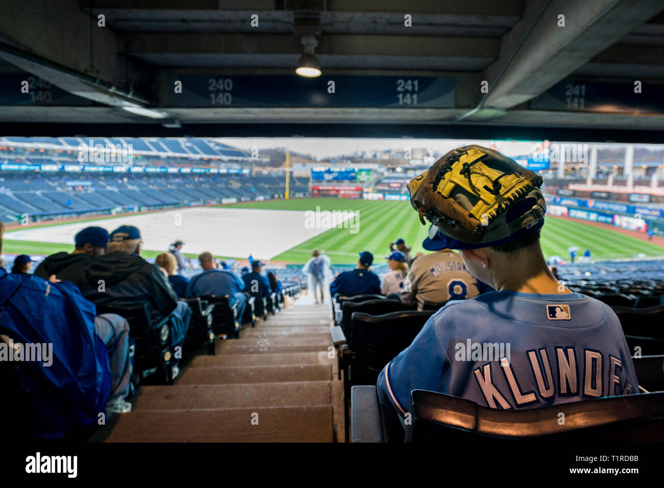 Kansas City, MO, USA. 28th Mar, 2019. Fans wait while rain delays the  Opening Day ceremonies for the Chicago White Sox vs the Kansas City Royals  at Kauffman Stadium in Kansas City
