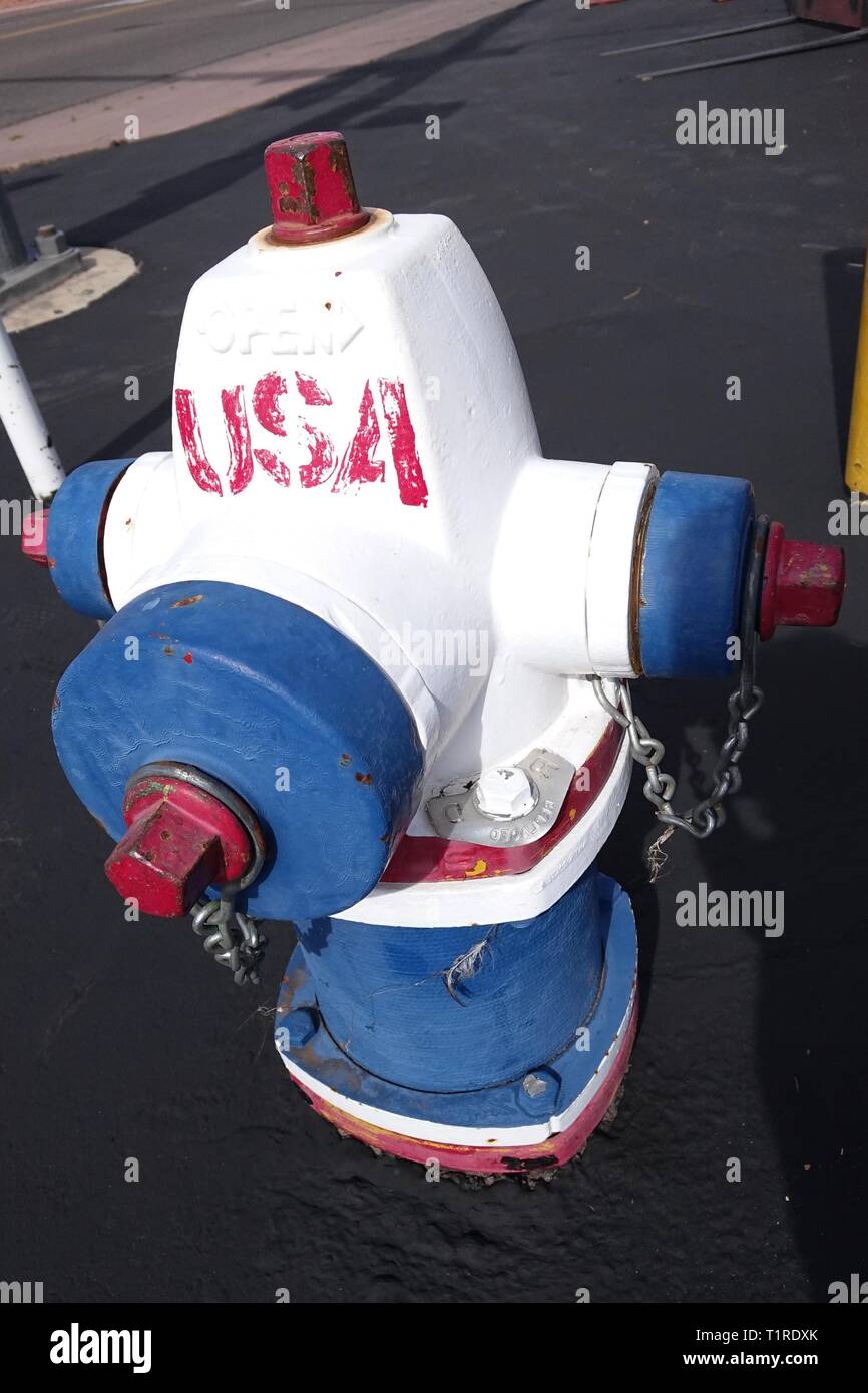 A fire hydrant is painted red, white, and blue in a symbol of patriotism in Page, Arizona. Stock Photo