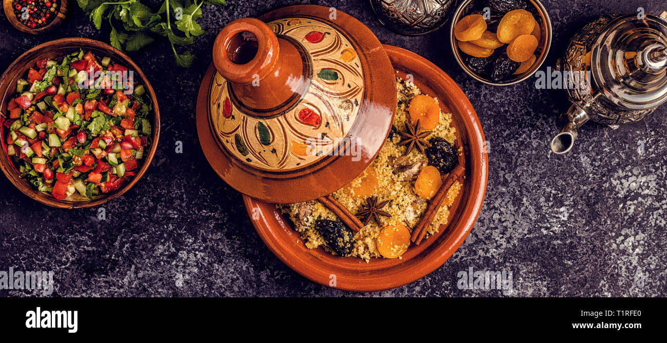 Traditional moroccan tajine of chicken with dried fruits and spices, top view. Stock Photo