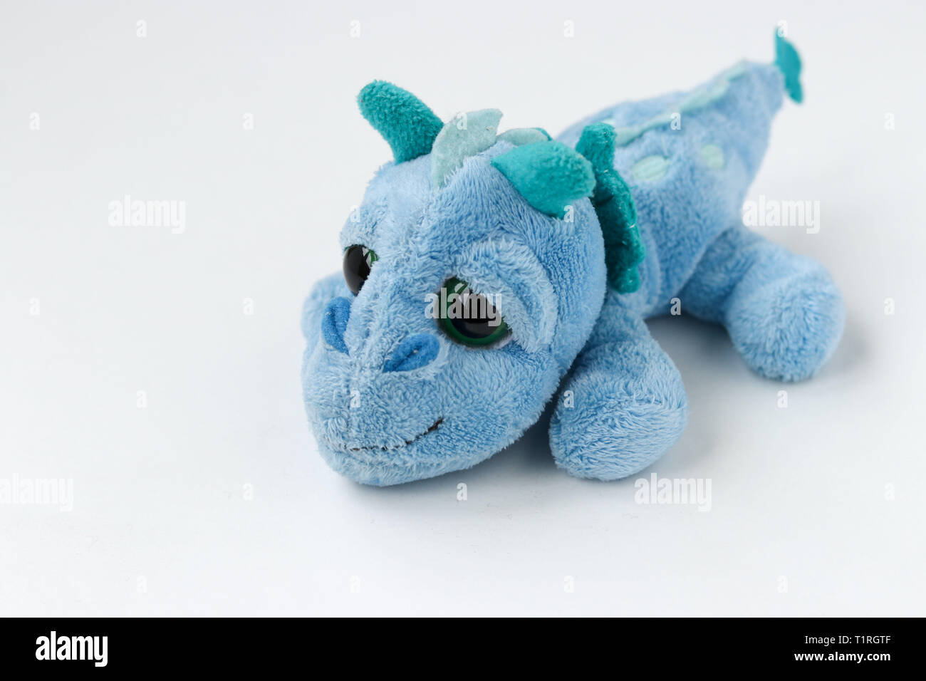 Children's soft toy blue dragon is located on a white background Stock Photo - Alamy Children's soft toy blue dragon is located on a white background Stock Photo - Alamy