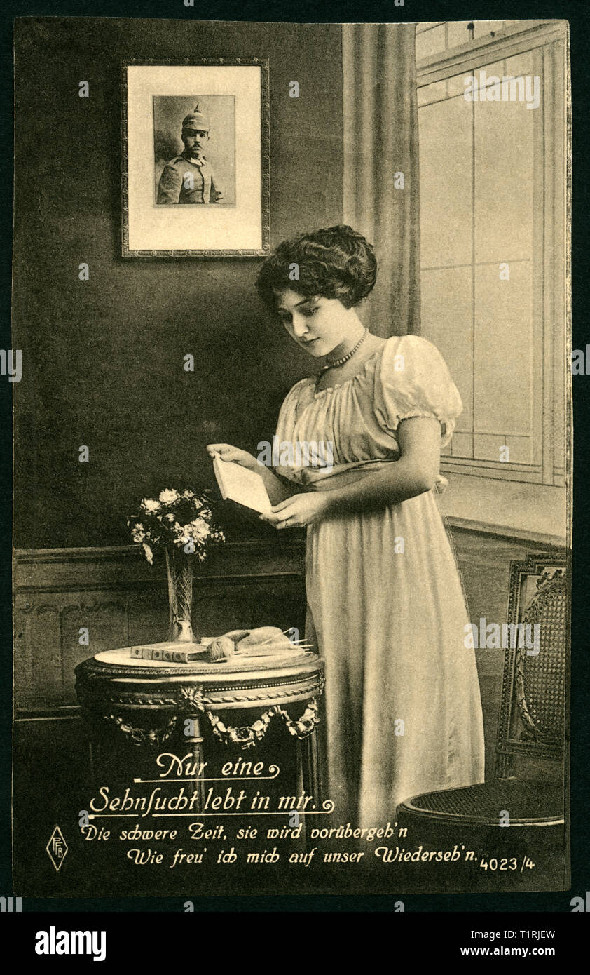 Germany, Berlin, WW I, propaganda, patriotic postcard, young wife is reading a letter from her husband or groom from the battlefield, there is also the text: 'Nur eine Sehnsucht lebt in mir. Die schwere Zeit, sie wird vorübergeh´n  - Wie freu ich mich auf unser Wiederseh´n.(Only longing lives inside me. The hard time will go away - I am happy to see you again), the postcard was sent 25. 06. 1916, artist - publishing house?, only to see ' PFB ' inside an rhombus, no more informations. , Additional-Rights-Clearance-Info-Not-Available Stock Photo