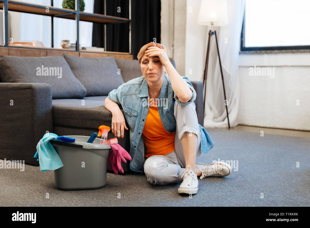 Tired distressed woman feeling sick after intense cleaning Stock Photo