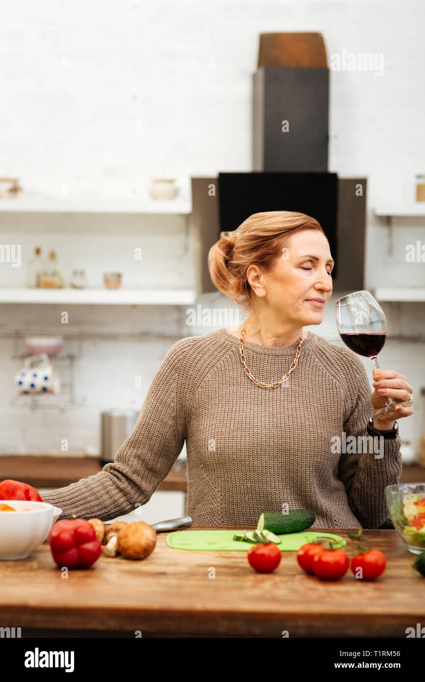 Peaceful good-looking woman with tied hair having calm evening Stock Photo