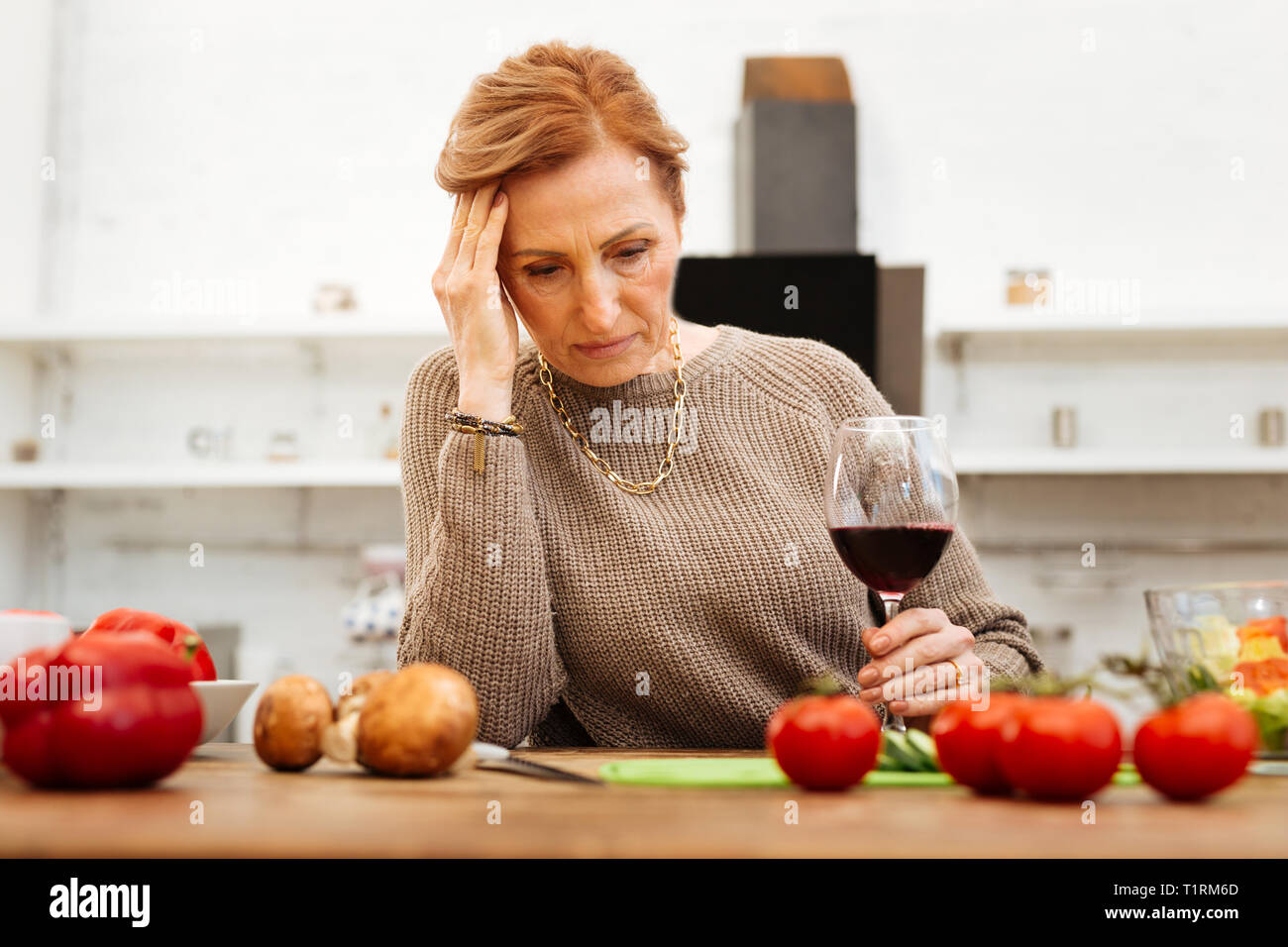 Upset good-looking lady with tied hair wearing warm beige sweater Stock Photo