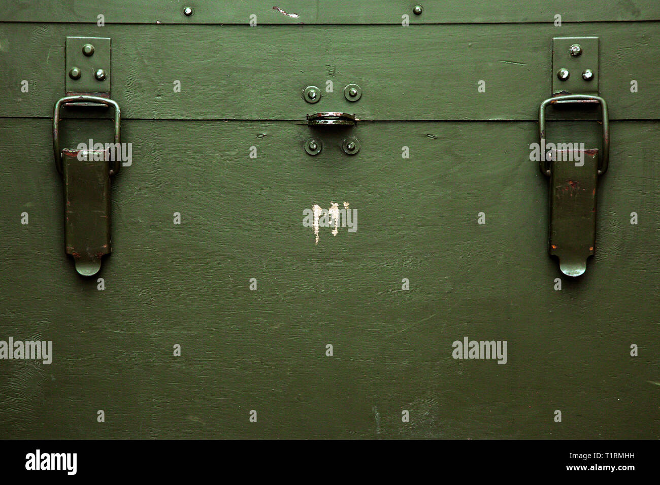 A green military storage box for ammunition. Green box from the war with scratches and locks in