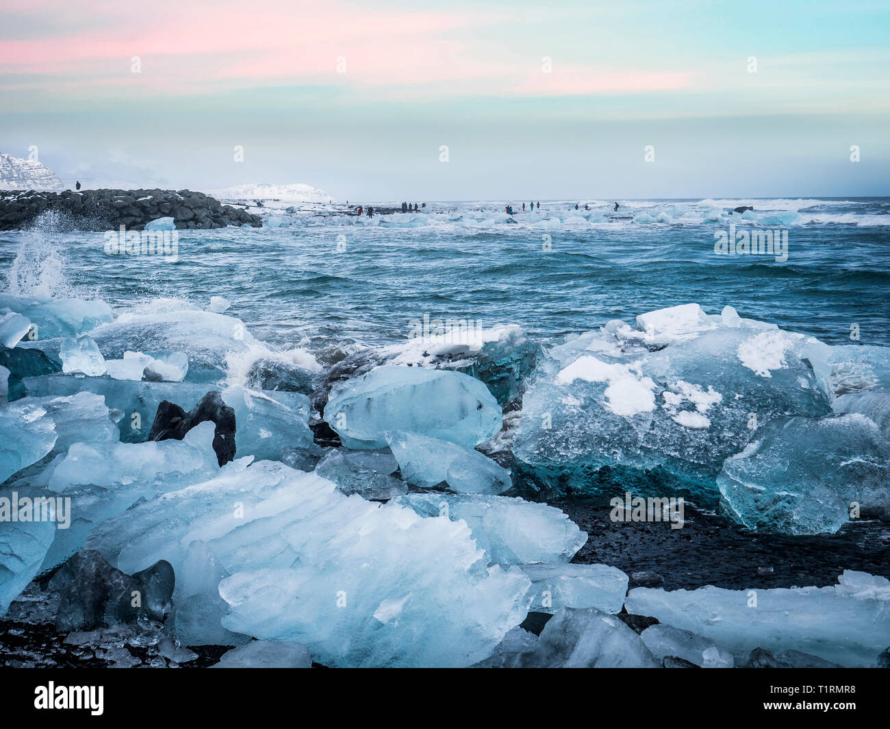 Waves splashing near icy shore in Iceland Stock Photo