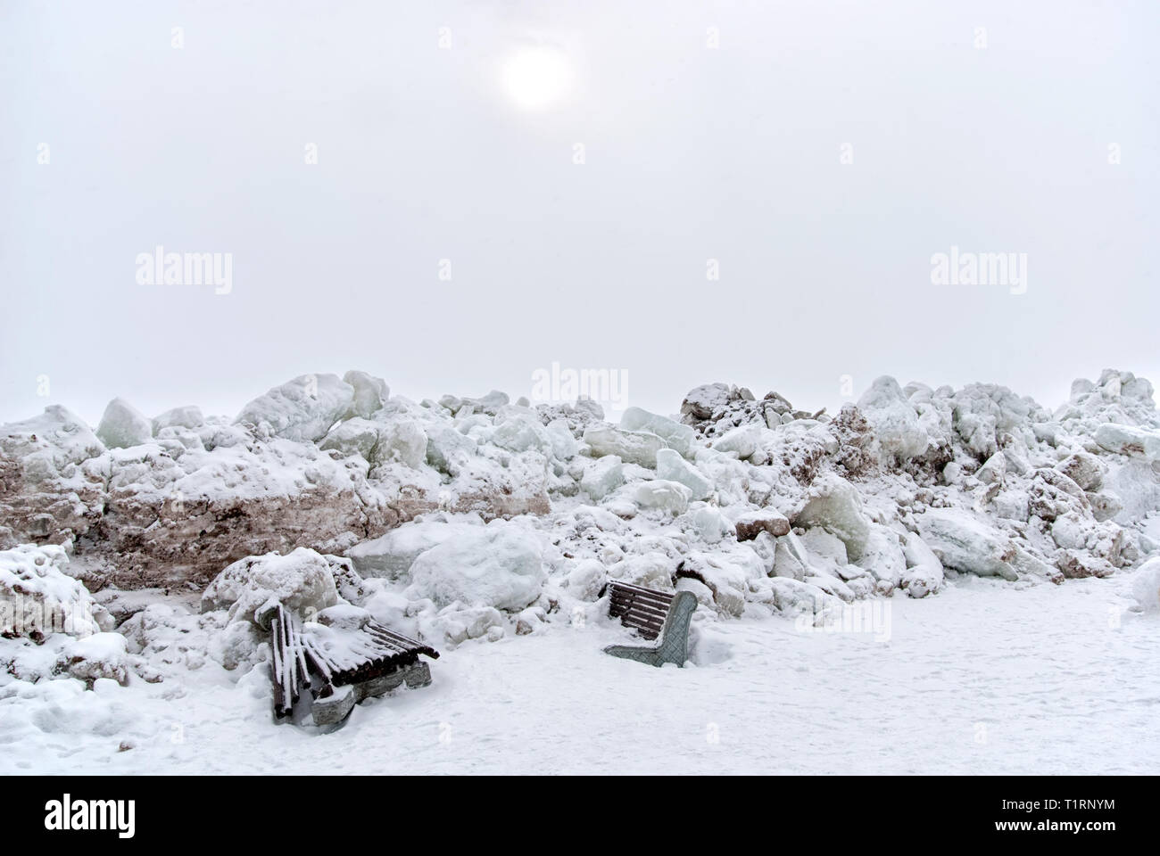 Broken benches by pressure ridges (ice floes) on The Gulf of Finland on the beach of Zelenogorsk Town (district of St Petersburg) in March. Russia Stock Photo