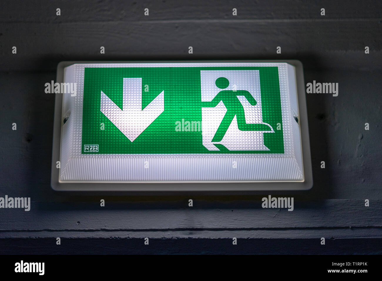 Illuminated information sign exit in the parking garage, old, dirty and ...