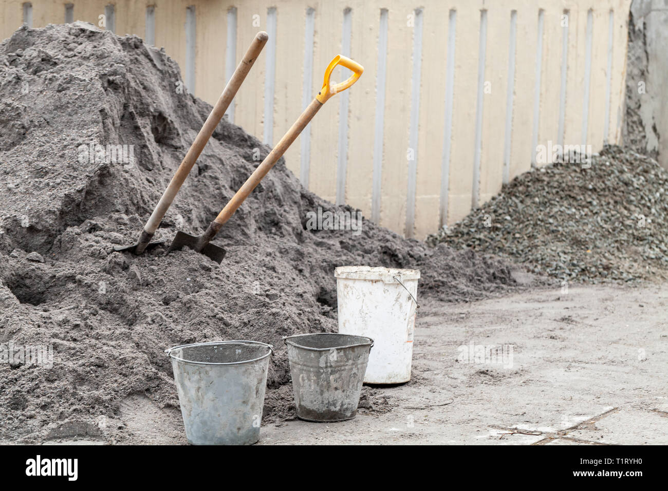 Pile of dry cement and spades with buckets Stock Photo Alamy