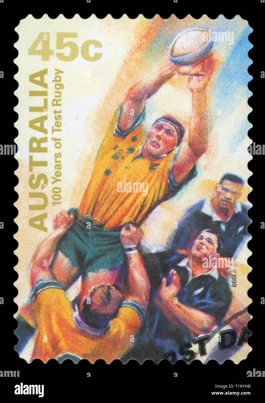 AUSTRALIA - CIRCA 1999: A Stamp printed in AUSTRALIA shows the Catching ball, 100 Years of Test Rugby, series, circa 1999. (Isolated on black) Stock Photo