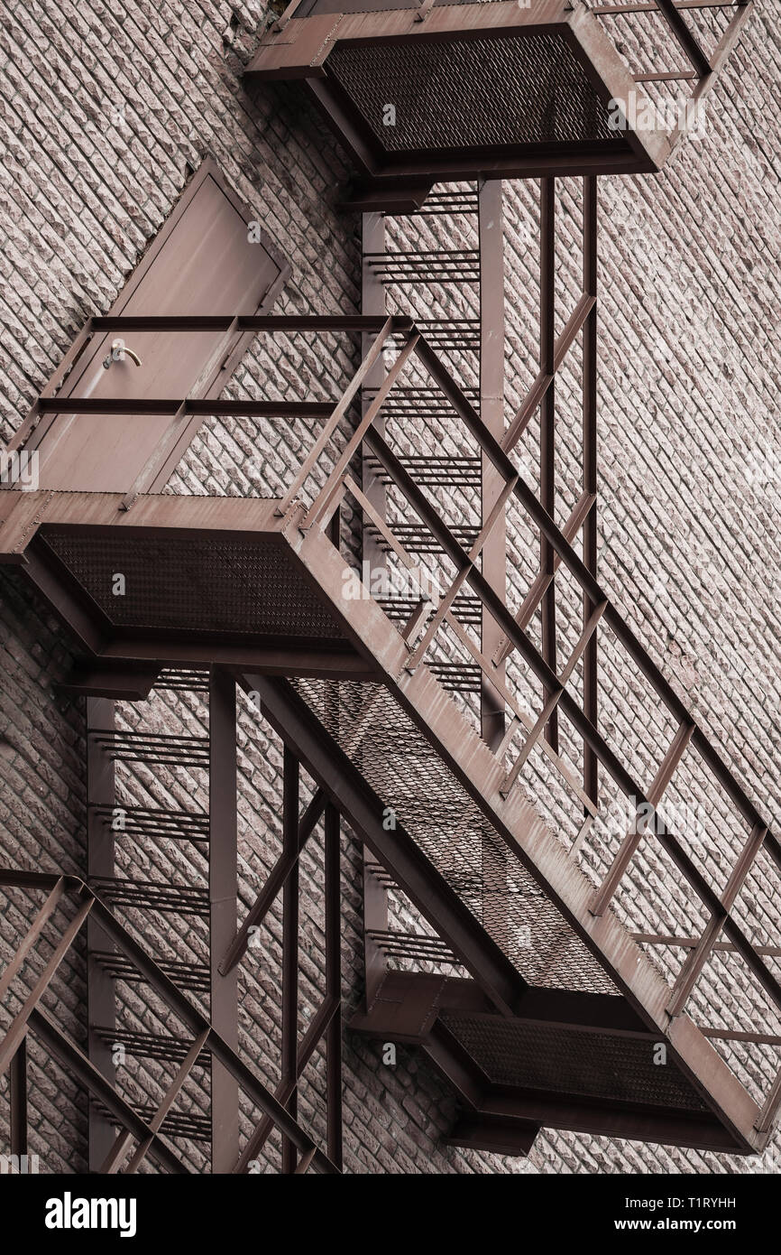 Abstract industrial architecture background, metal stairway over red brick wall Stock Photo