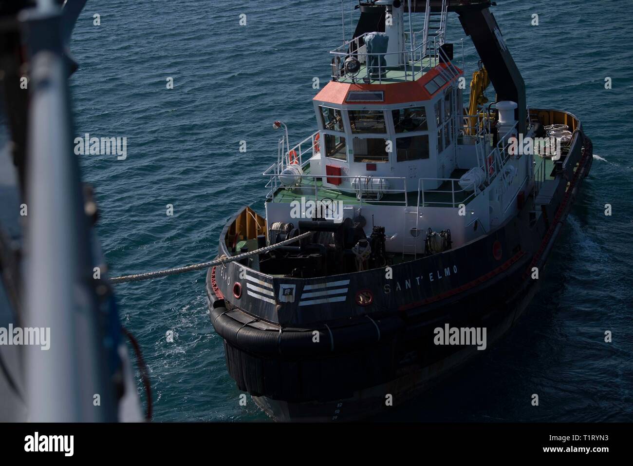 190323-N-GA520-0393      GAETA, Italy (March 23, 2019) – A tug assists the Blue Ridge-class command and control ship USS Mount Whitney (LCC 20) in docking pierside March 23, 2019.  Mount Whitney, forward deployed to Gaeta, Italy, operates with a combined crew of U.S. Navy Sailors and Military Sealift Command civil service mariners. (U.S. Navy photo by Mass Communication Specialist 1st Class Charles Hayes/Released) Stock Photo