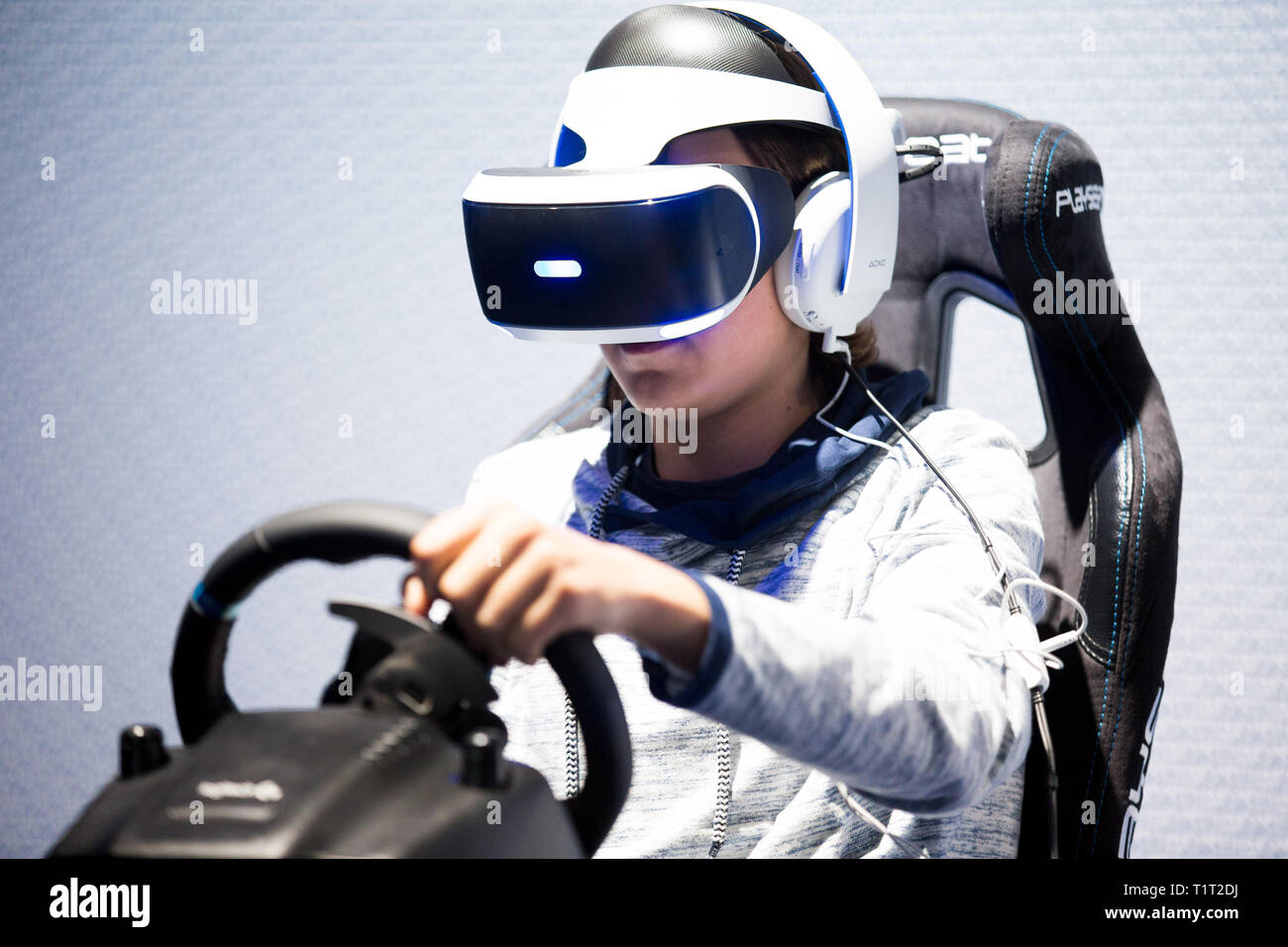 HELSINKI, FINLAND - NOVEMBER 4, 2016: VR games. Teens use virtual reality helmets Sony PlayStation 4, racing simulator. Stock Photo