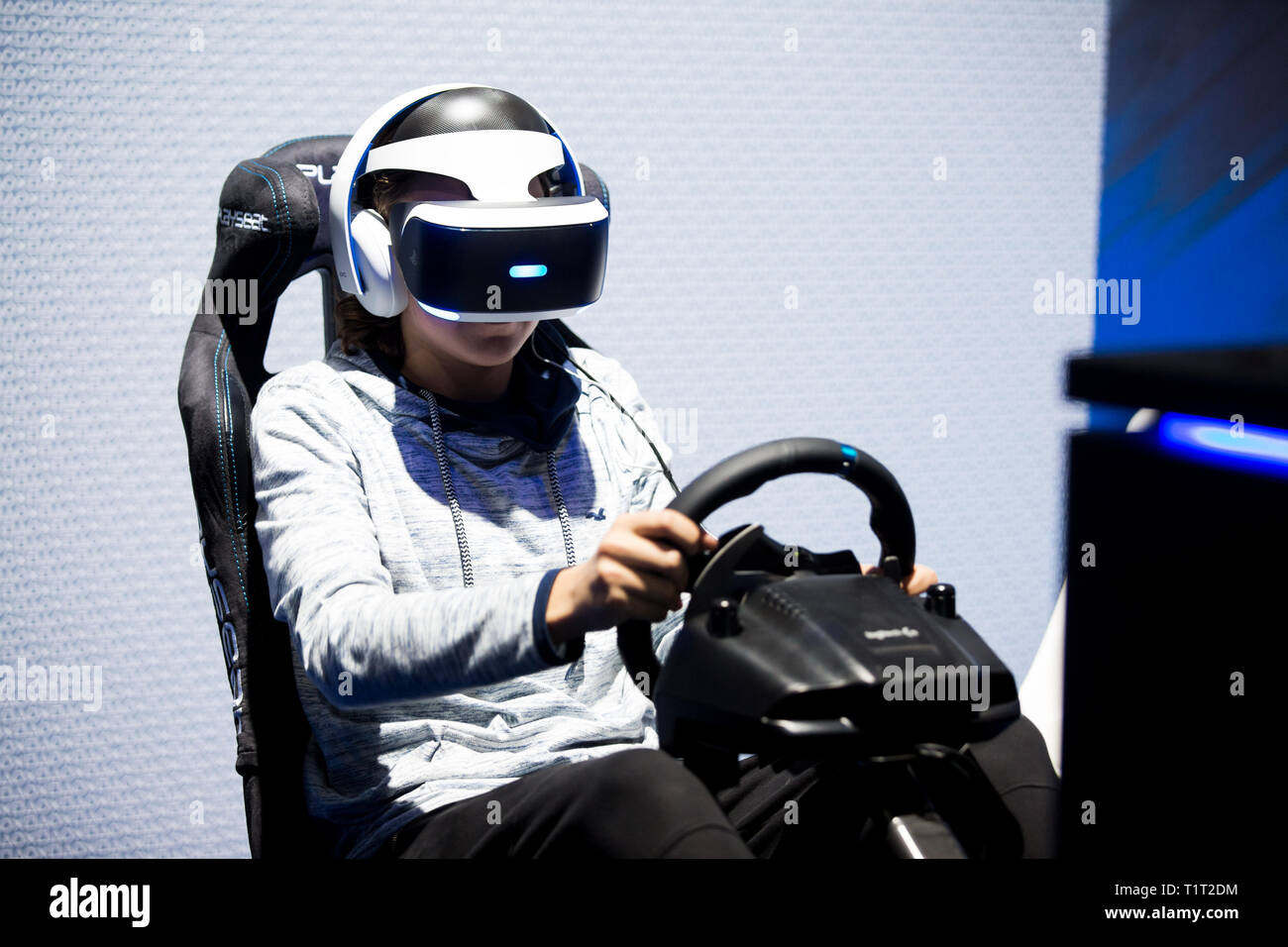 HELSINKI, FINLAND - NOVEMBER 4, 2016: VR games. Teens use virtual reality helmets Sony PlayStation 4, racing simulator. Stock Photo