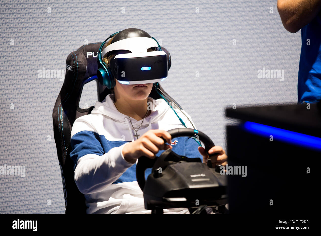 HELSINKI, FINLAND - NOVEMBER 4, 2016: VR games. Teens use virtual reality helmets Sony PlayStation 4, racing simulator. Stock Photo