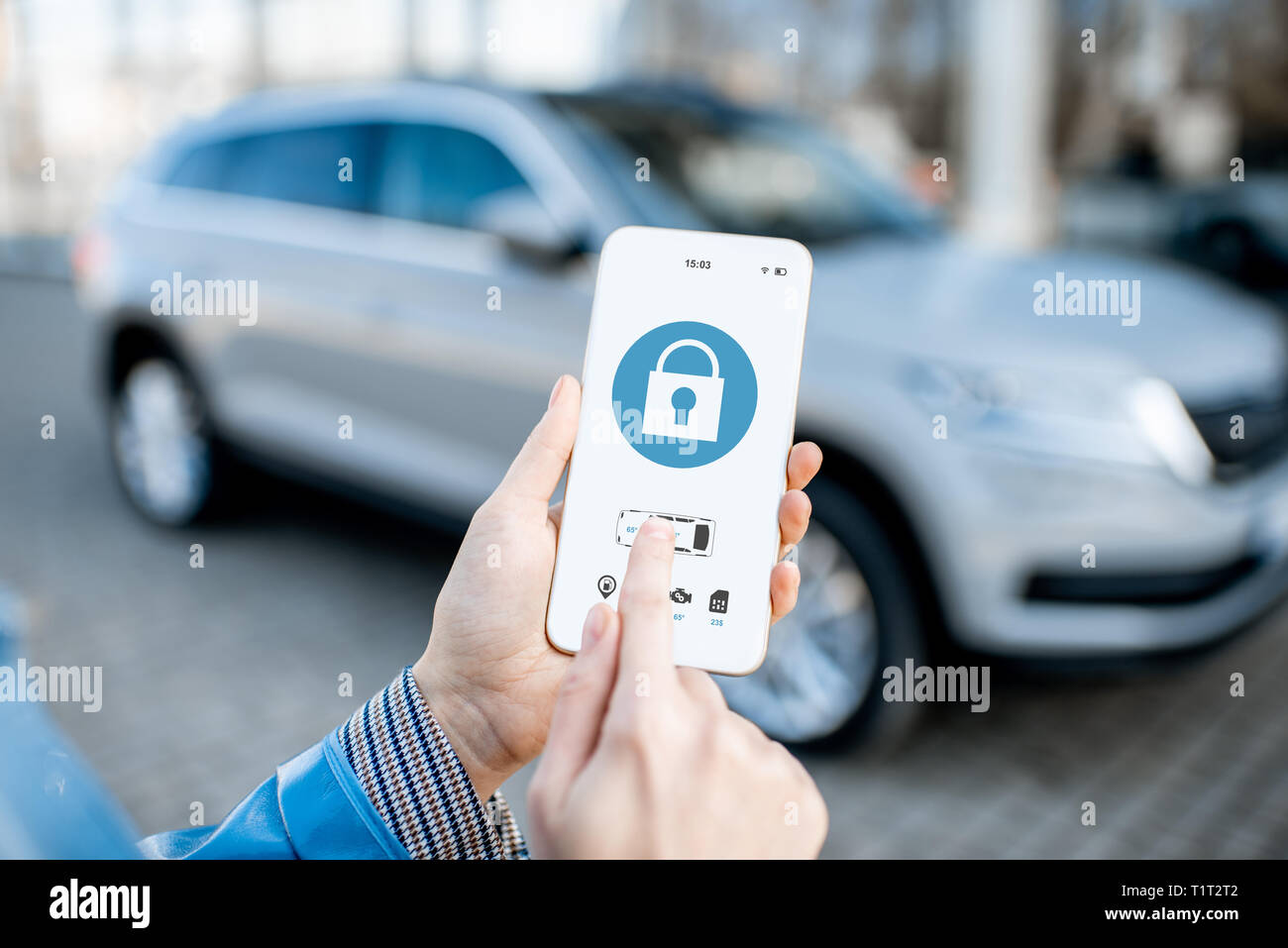 Locking car using mobile application on a smart phone. Concept of remote control and car protection through the internet Stock Photo