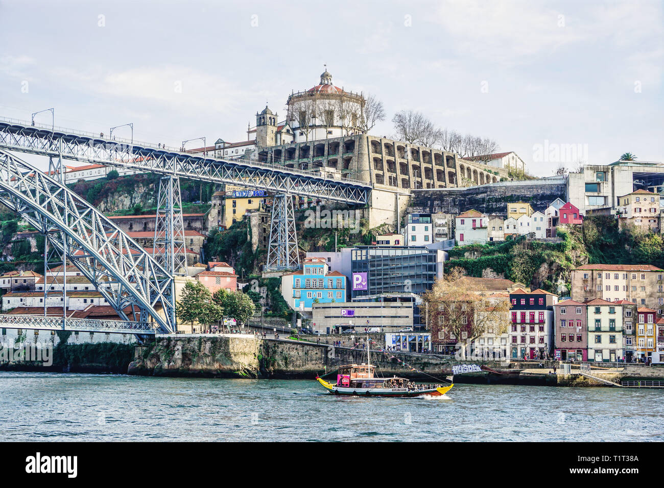 Porto, Portugal - December 2018: Rabelo Boat with tourists in Douro River. Luis I Bridge and Monastery of Serra do Pilar Stock Photo