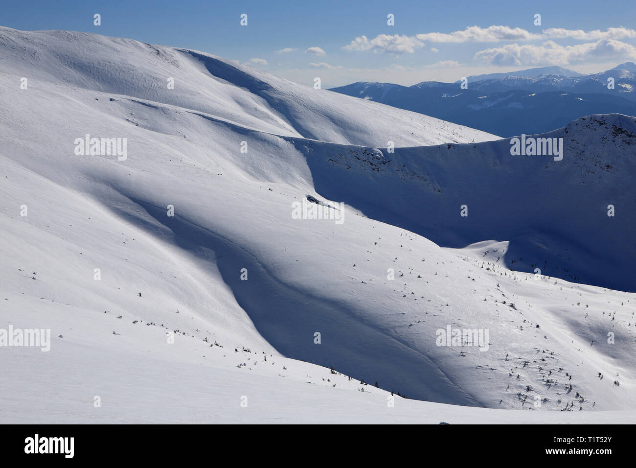 The mountains are covered with snow under a bright blue sky Stock Photo ...
