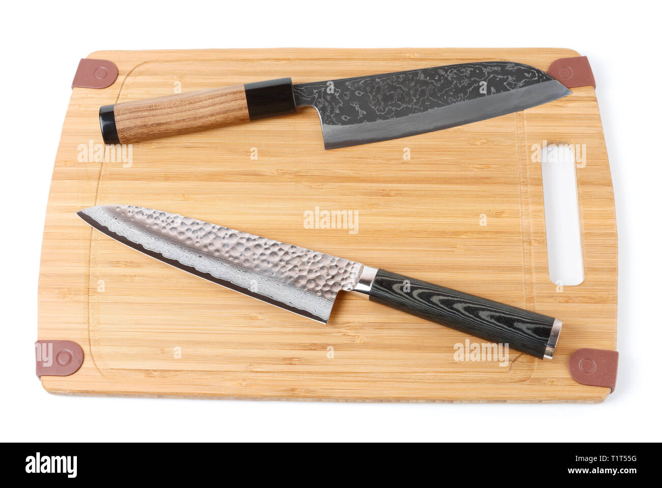 Two top grade japanese knives on bamboo cutting board, isolated Stock Photo