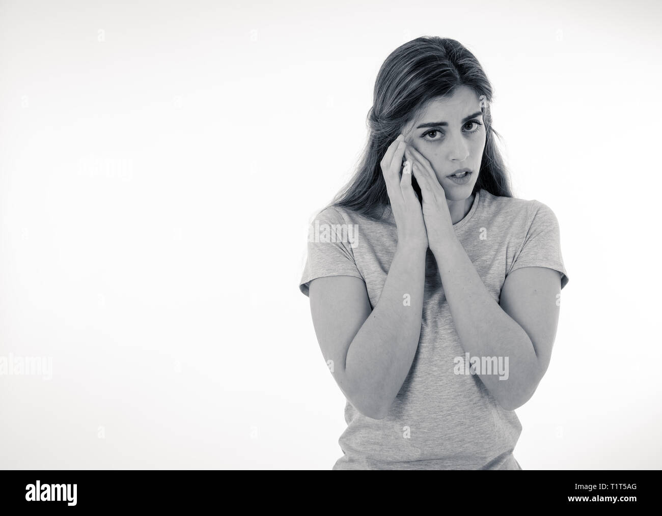 Young sad woman, intimidate and concerned, looking worried and upset, feeling sorrow and fear. In people, facial expressions and emotion concept. Blac Stock Photo