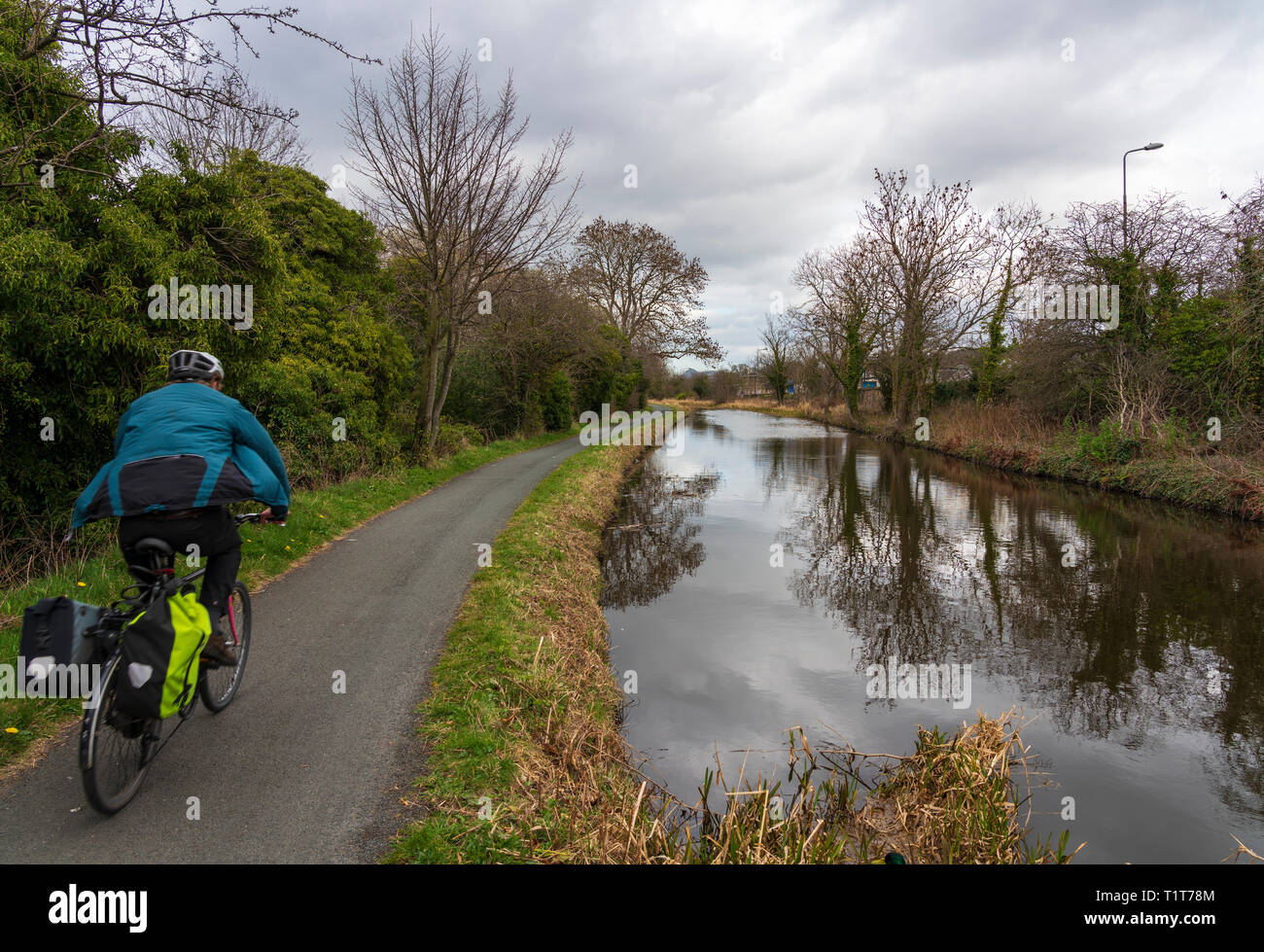 Cyclist on the towpath of the Union Canal in early spring  in Edinburgh, Scotland, UK Stock Photo