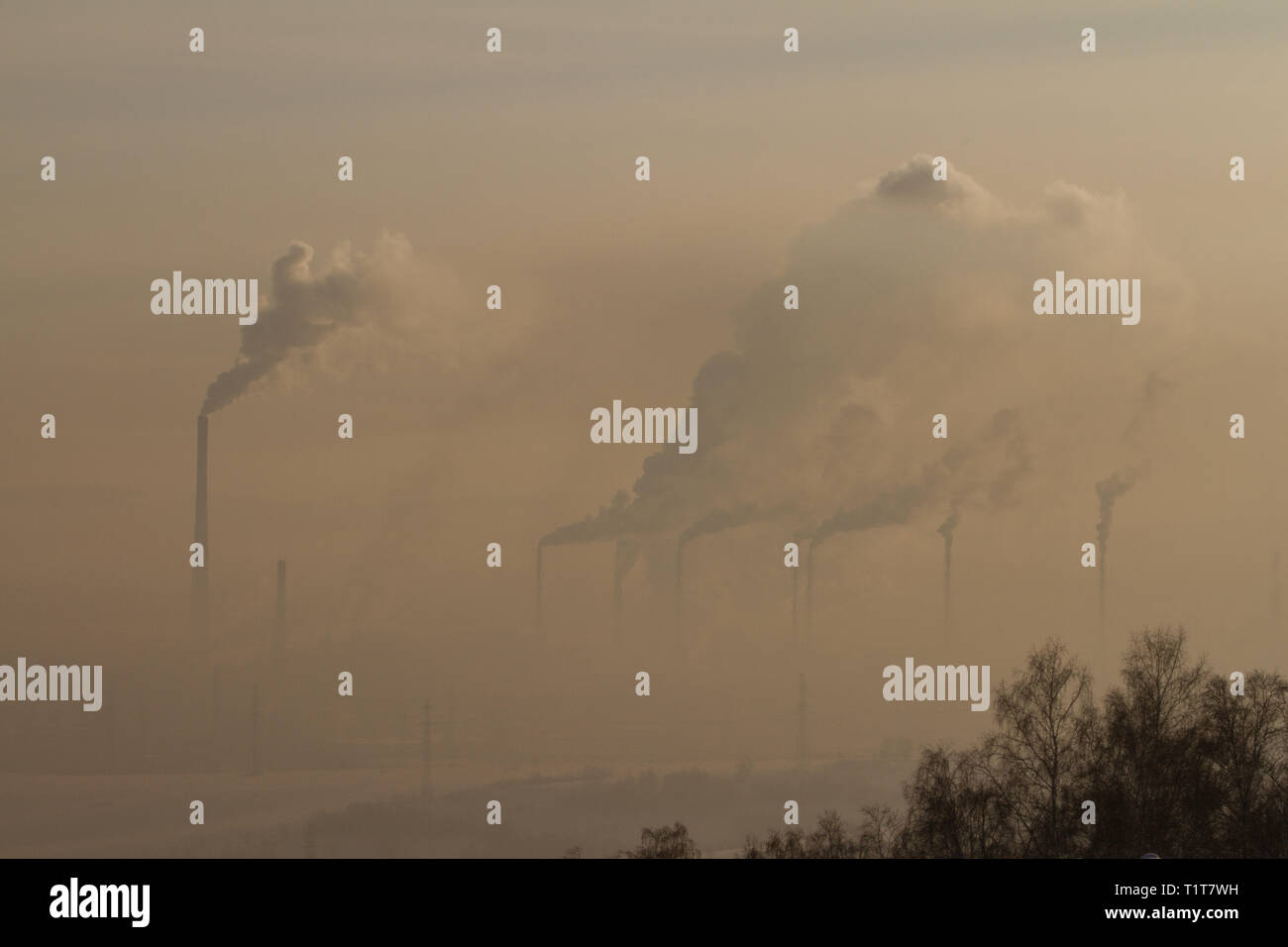 Power plant with smoke and dirty orange air Stock Photo