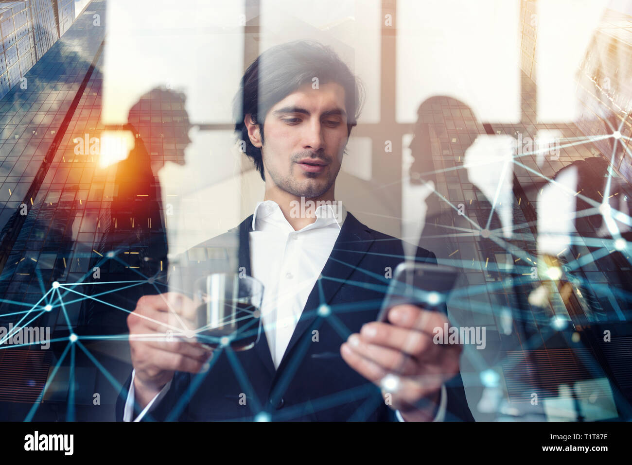 Businessman works with his smartphone in office. double exposure. Stock Photo