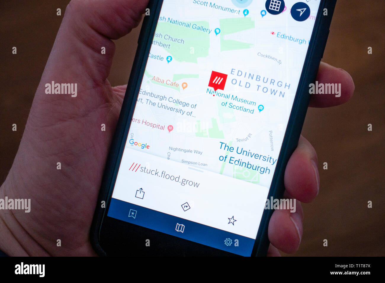 Using a mobile phone to use What3words location finding app Stock Photo