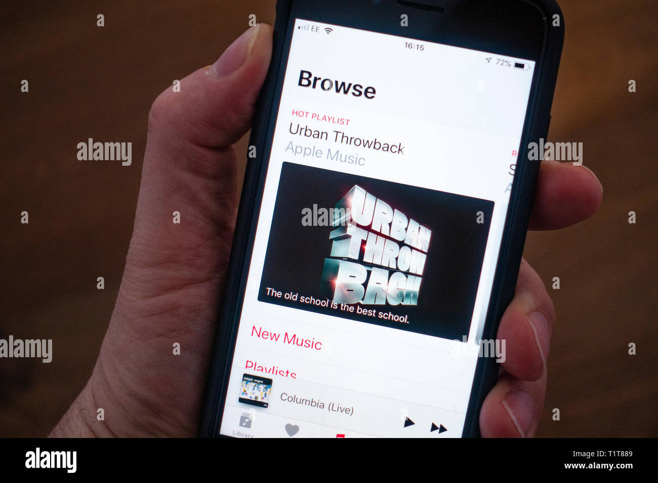Using a mobile phone to browse Apple Music app Stock Photo