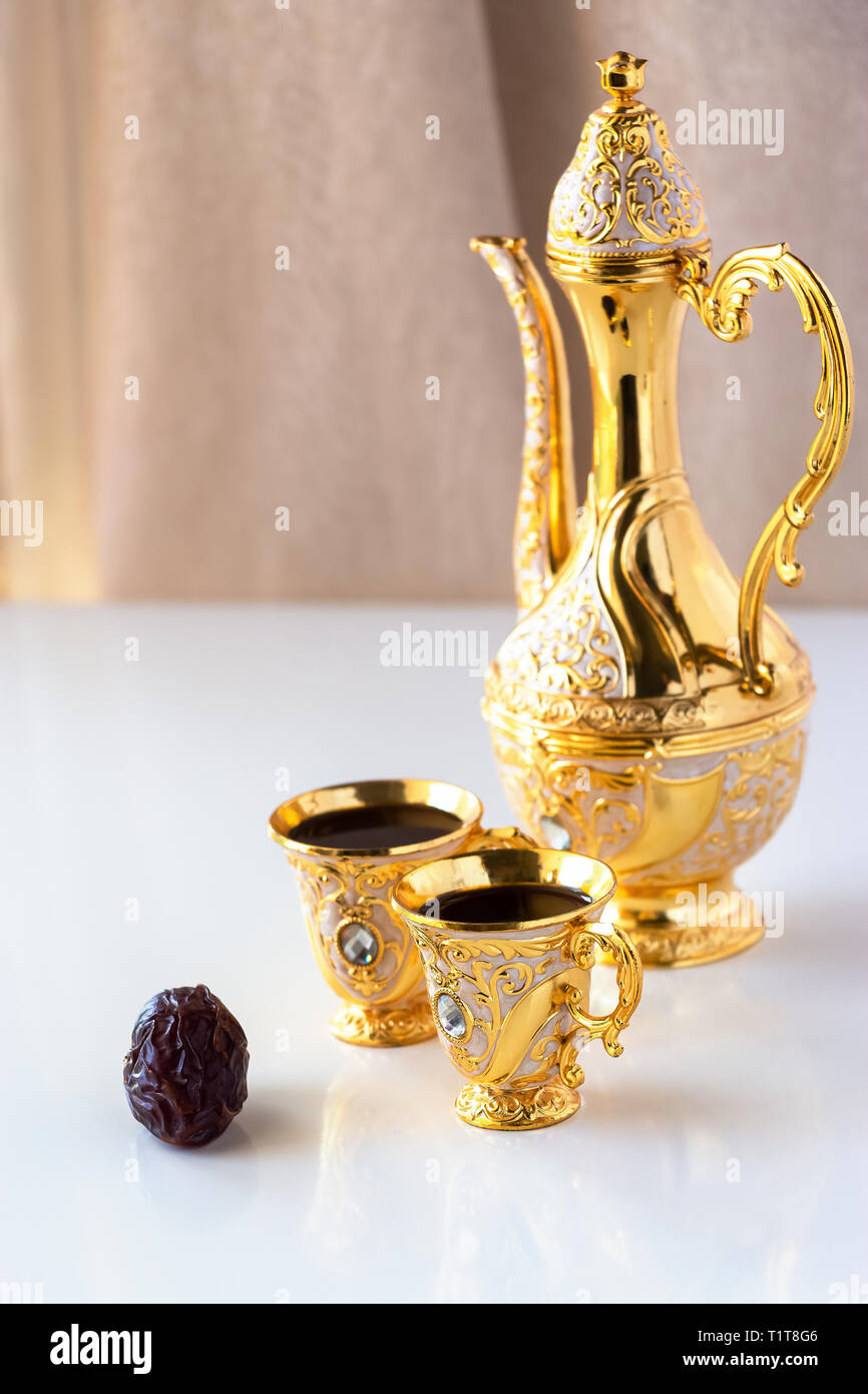 https://c8.alamy.com/comp/T1T8G6/still-life-with-traditional-golden-arabic-coffee-set-with-dallah-and-cup-white-background-ramadan-concept-T1T8G6.jpg