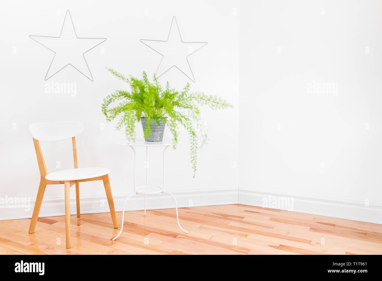 Bright Room Corner With Metal Stars Decorating White Walls Simple