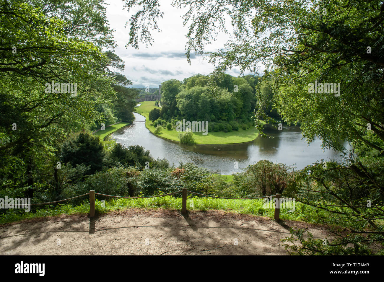 A view of Fountains Abbey, through the trees and over the River Skell. Stock Photo