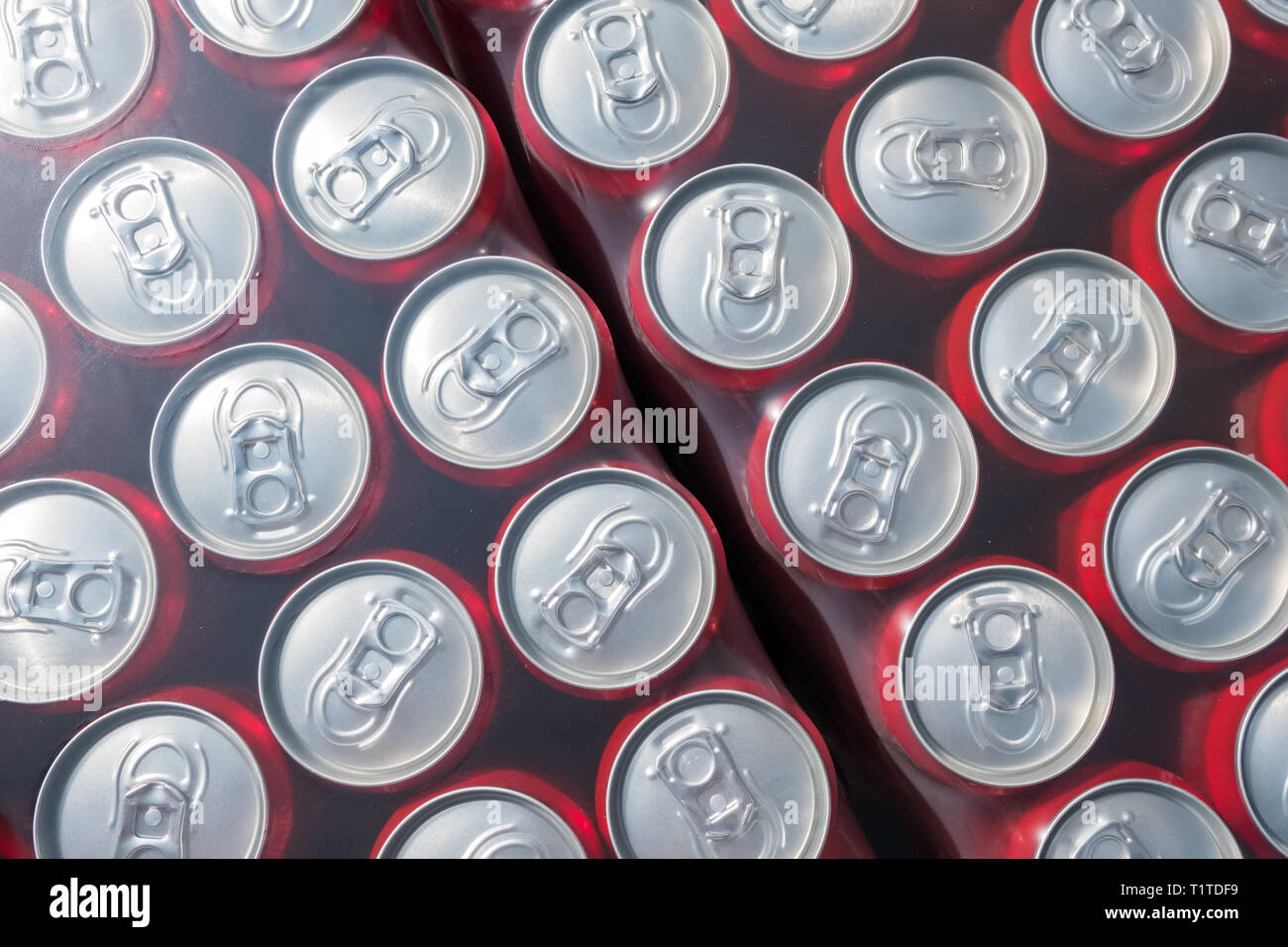 Red  aluminium cans packed in plastick background, view from the top Stock Photo
