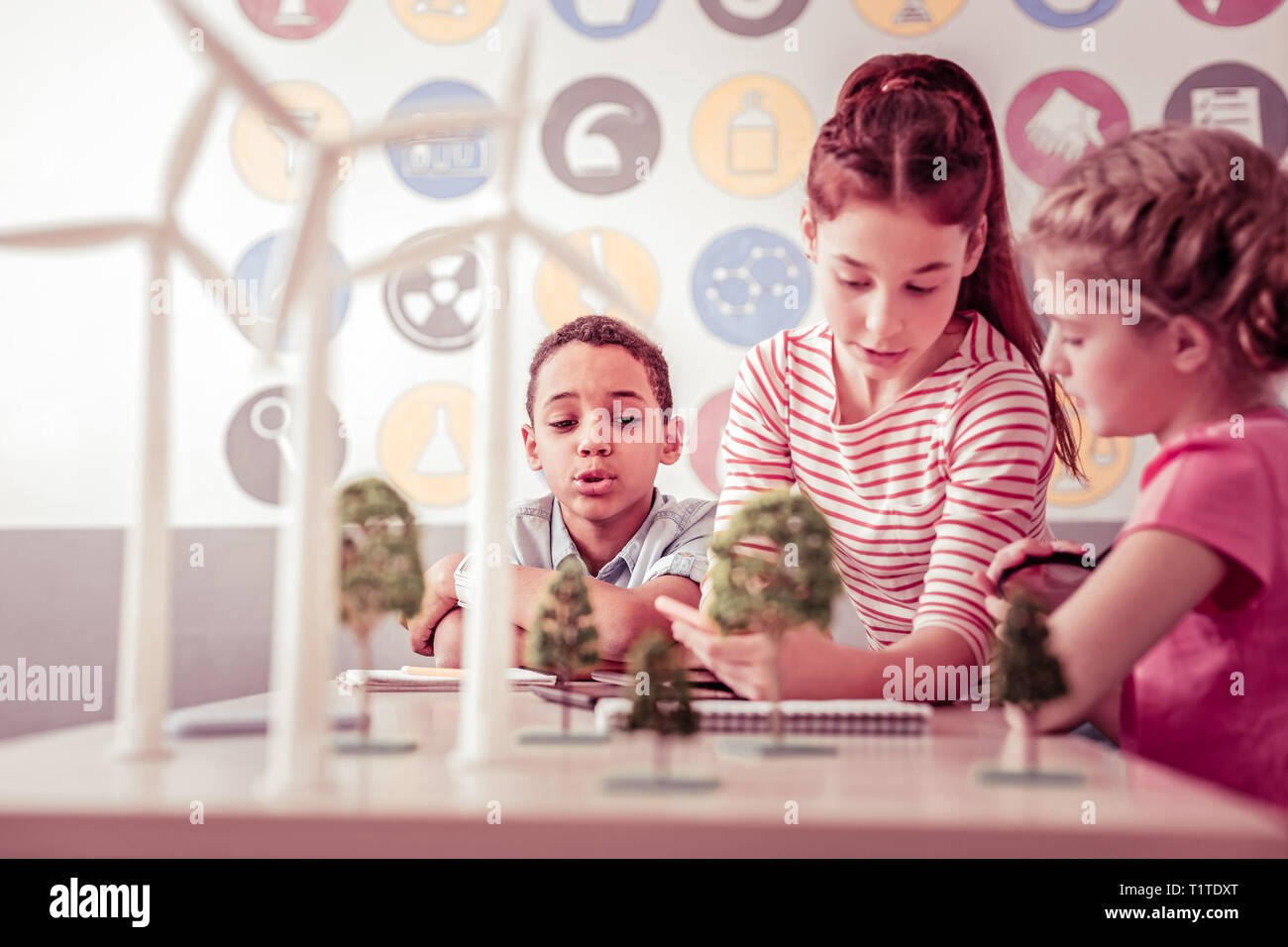 Curious little scientists sitting in class and exploring alternative energy Stock Photo