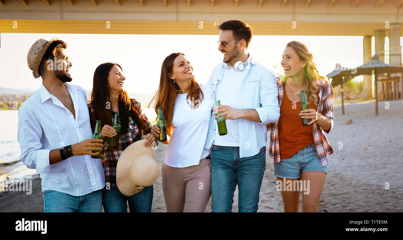 Beach party with friends. Cheerful young people spending nice time together on the beach Stock Photo