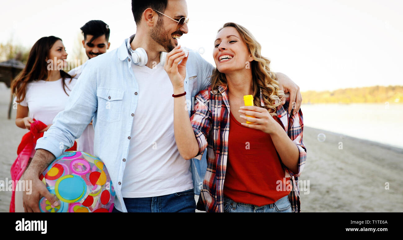 Happy group of young people having fun on beach Stock Photo