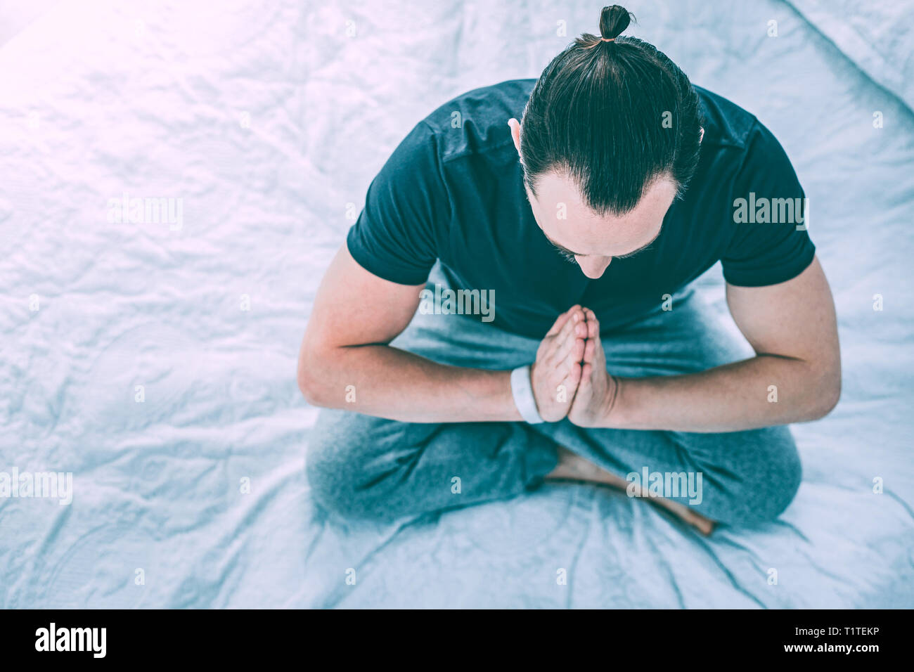 Refreshed relaxed man practicing yoga in a room Stock Photo