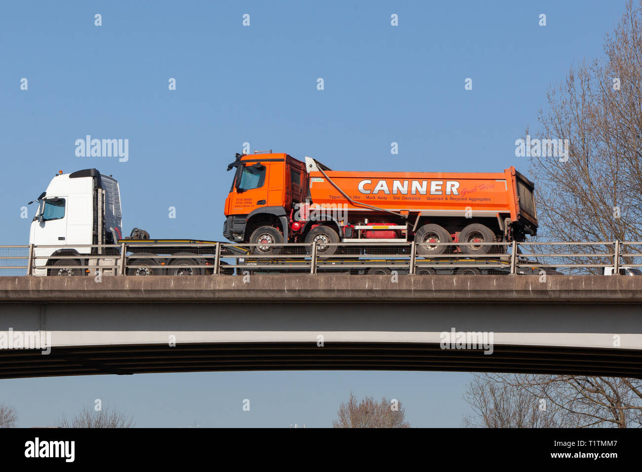 Tipper truck being transported on a low loader trailer. Travelling on ...