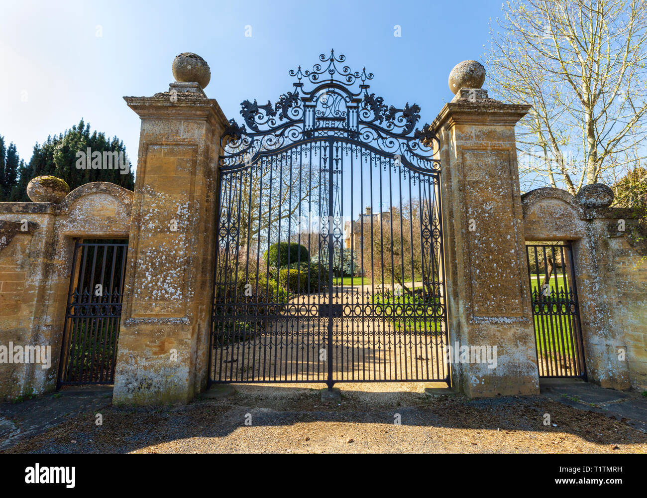 The entrance iron gates to Overbury Court in the unspoilt Cotswold village of Overbury, Worcestershire, England Stock Photo
