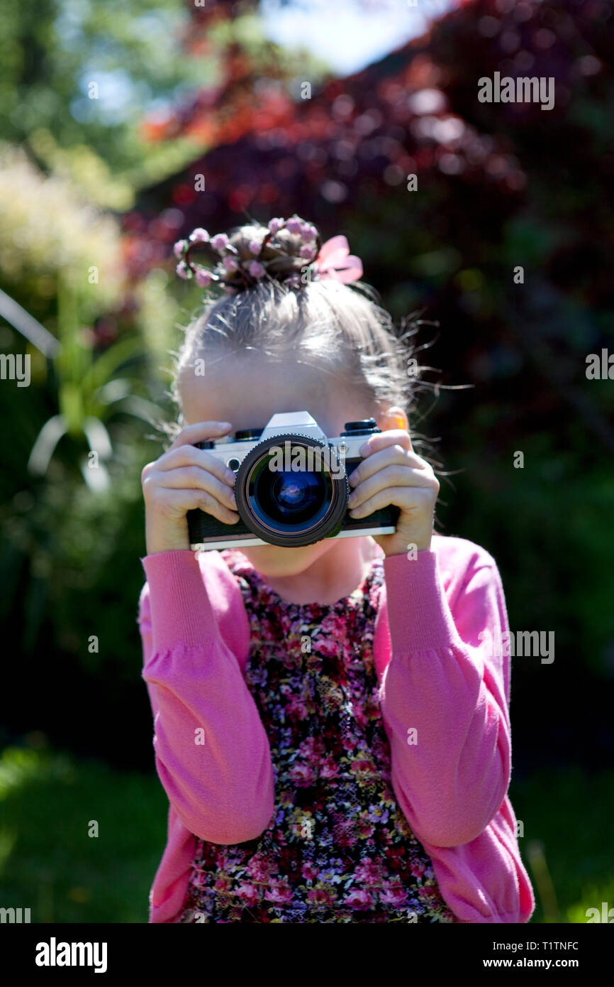 Child using an old SLR film camera to take a photograph Stock Photo Alamy