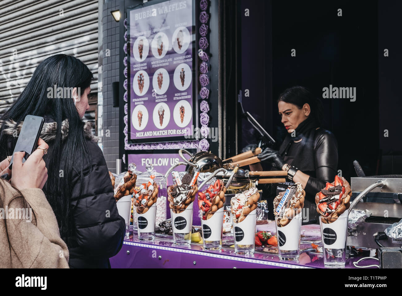 London Uk March 23 19 Customers Buying Bubble Waffles At A Stall Inside Camden Market London Started With 16 Stalls In 1974 Camden Market Is Stock Photo Alamy