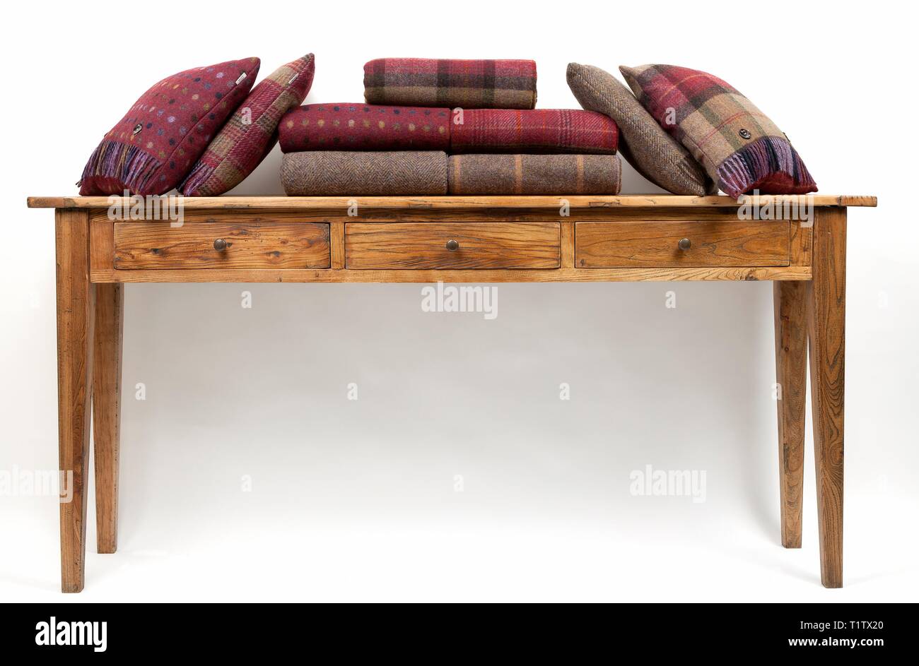 Sideboard style table with cushions on a white background Stock Photo