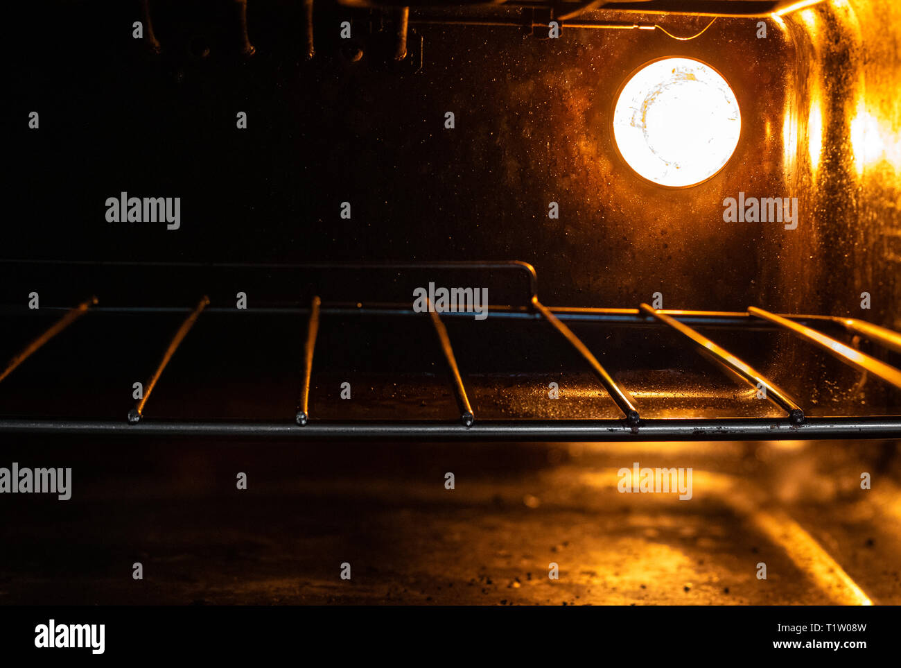 Inside of Oven/Grill/Cooker with Bright Orange Light on Illuminating