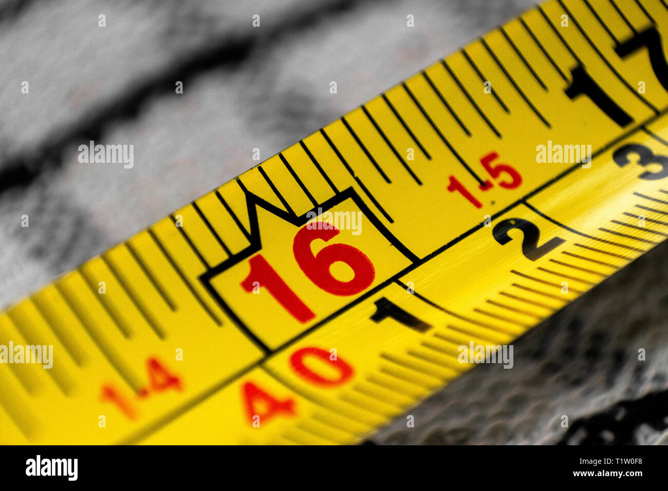Yellow Tape Measure Showing Measurement In Metres And Feet Stock Photo yellow-tape-measure-showing-measurement-in-metres-and-feet-stock-photo