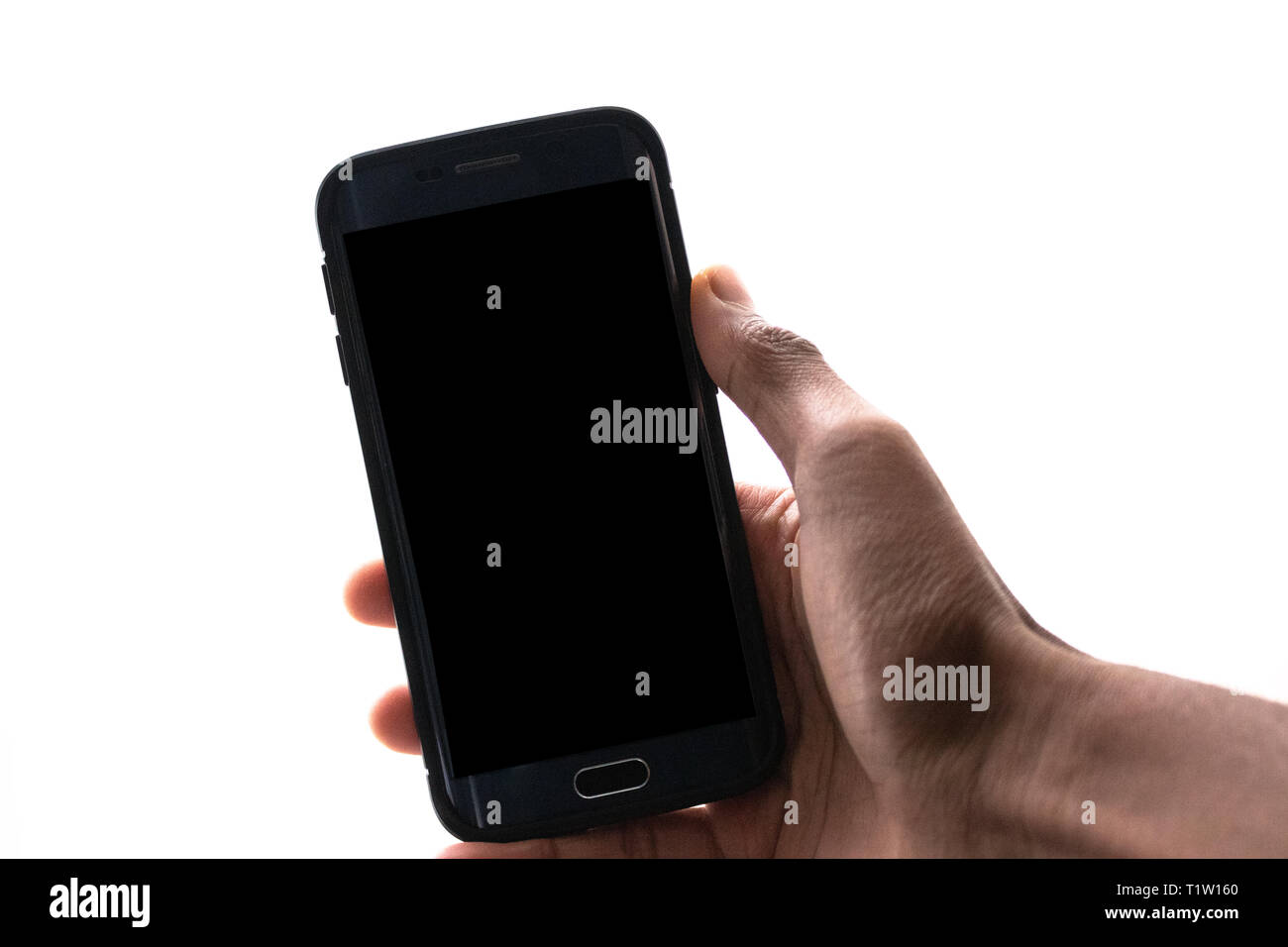 Man hand holding the black smartphone with big blank screen and modern ...