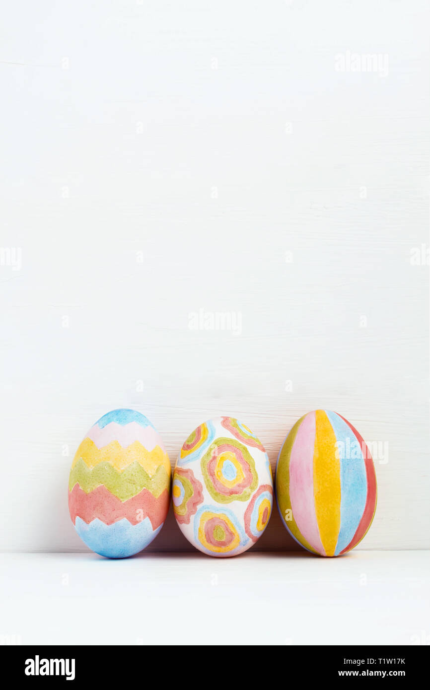 Сolorful Easter eggs decorated with geometric patterns on white background Stock Photo