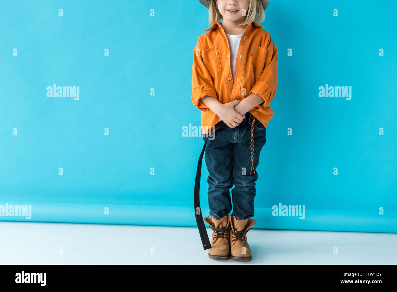 orange shirt and blue jeans
