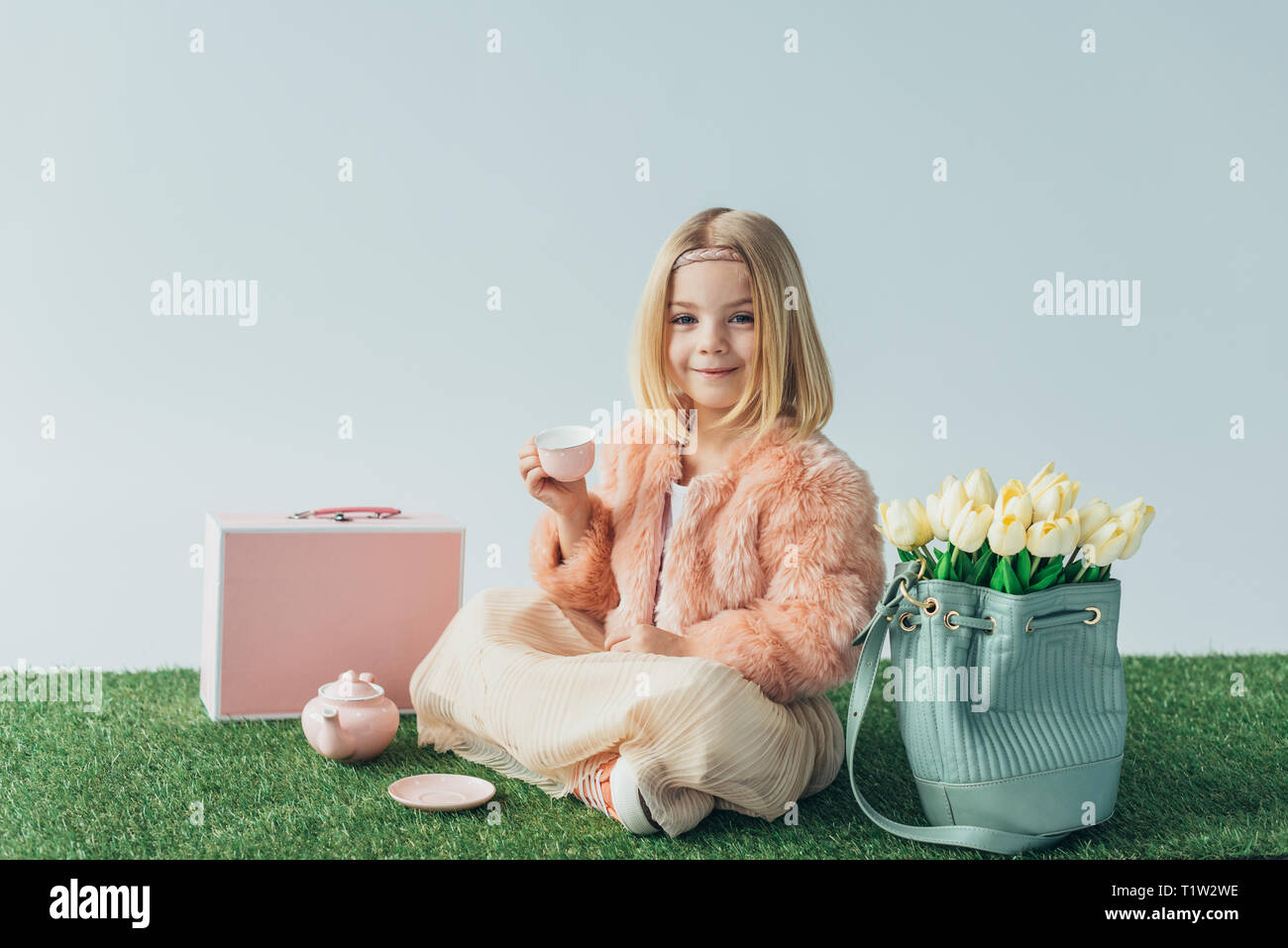 Smiling blonde girl sitting crossed hi-res stock photography and images ...